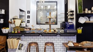 A kitchen counter with various food items and a coffee machine. - Le Boutik Hotel (Annecy)