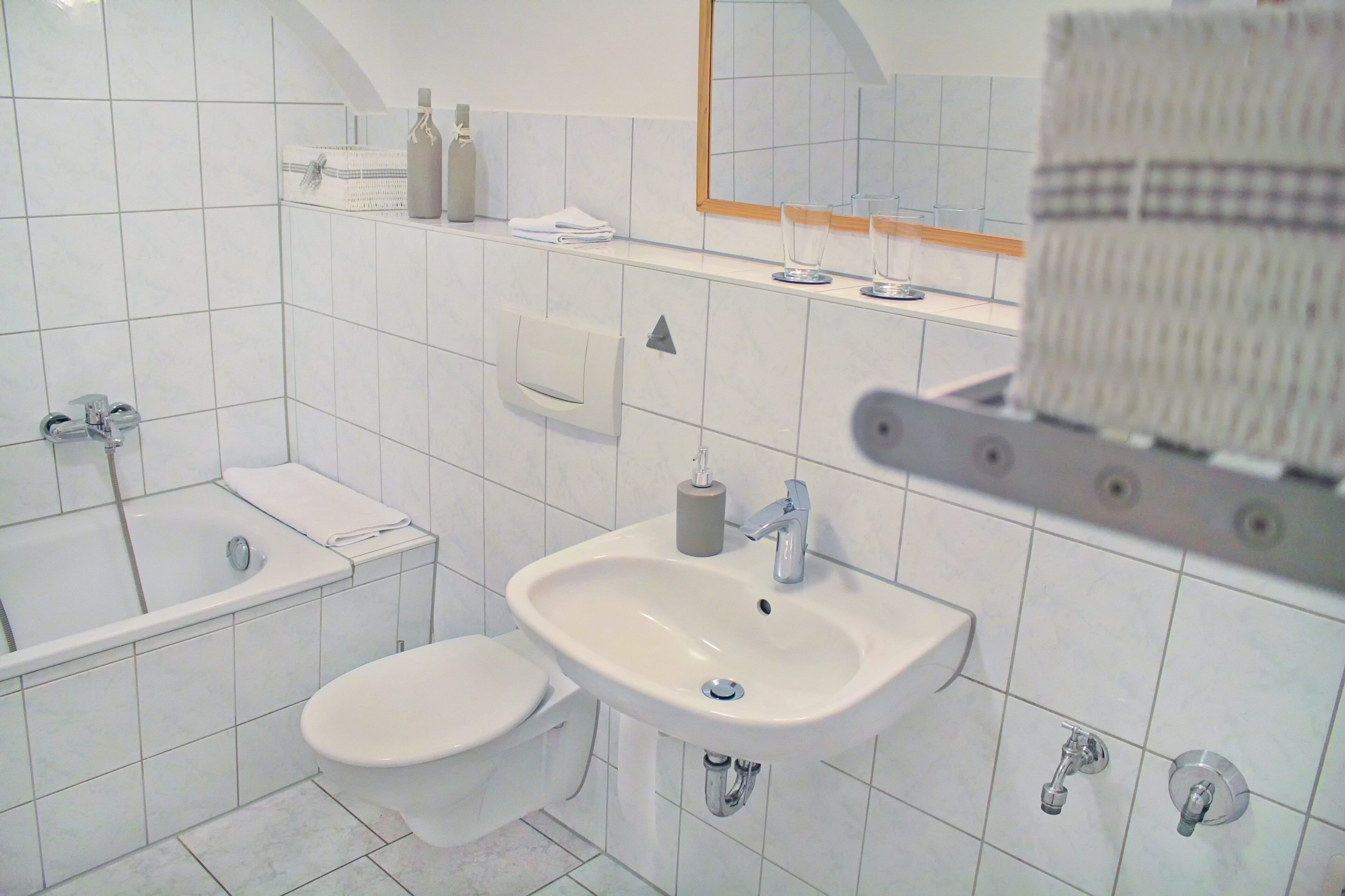 A modern bathroom with a bathtub, toilet, and sink.