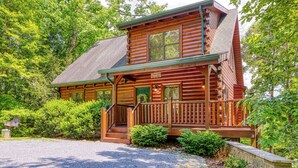 A log cabin with a porch, a staircase, and a sign that reads 'Sweet Dreams.' - Sweet Dreams is a beautiful 2 bedroom and 2 bath log cabin (Sevierville)