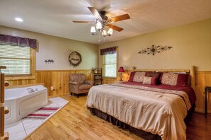 A bedroom with a bed, a chair, a vanity, and a ceiling fan. - Amazing Views - The name says it all! (Sevierville)