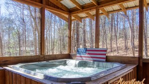 A wooden cabin with a hot tub, surrounded by a forest. - Diamond In The Rough, is a terrific family or group cabin. Pigeon Forge Cabin (Sevierville)