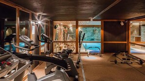 A gym with treadmills, stationary bikes, and weight equipment.