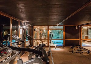 A gym with treadmills, stationary bikes, and weight equipment.