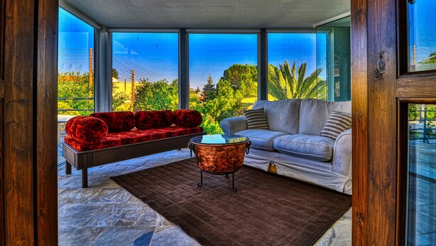A modern living room with a red sofa, a grey sofa, and a copper coffee table. - Estia Anogaia Cottage (Ora)