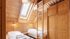 A wooden cabin with two beds, a skylight, and a ladder. - Snug Holiday Home in Sankt Georgen ob Murau near Kreischberg (Sankt Georgen am Kreischberg)