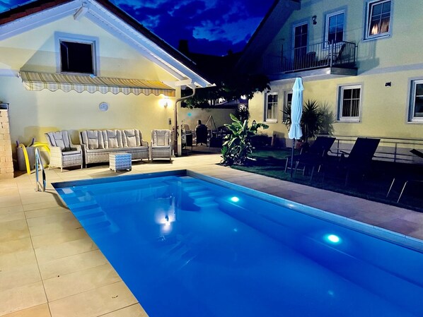 Outdoor pool, a heated pool, sun loungers
