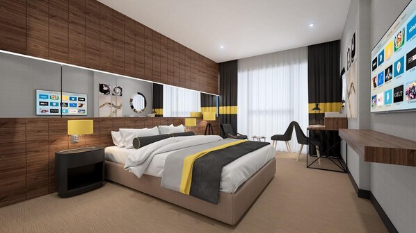Una habitación de hotel moderna con una cama grande, un escritorio y una zona de estar.