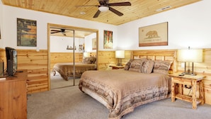 A bedroom with a large bed, wooden headboard, a ceiling fan, and a California Republic poster. - Circle Views #1602 (Big Bear Lake)