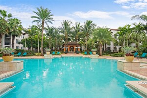 Una piscina al aire libre de temporada, sombrillas
