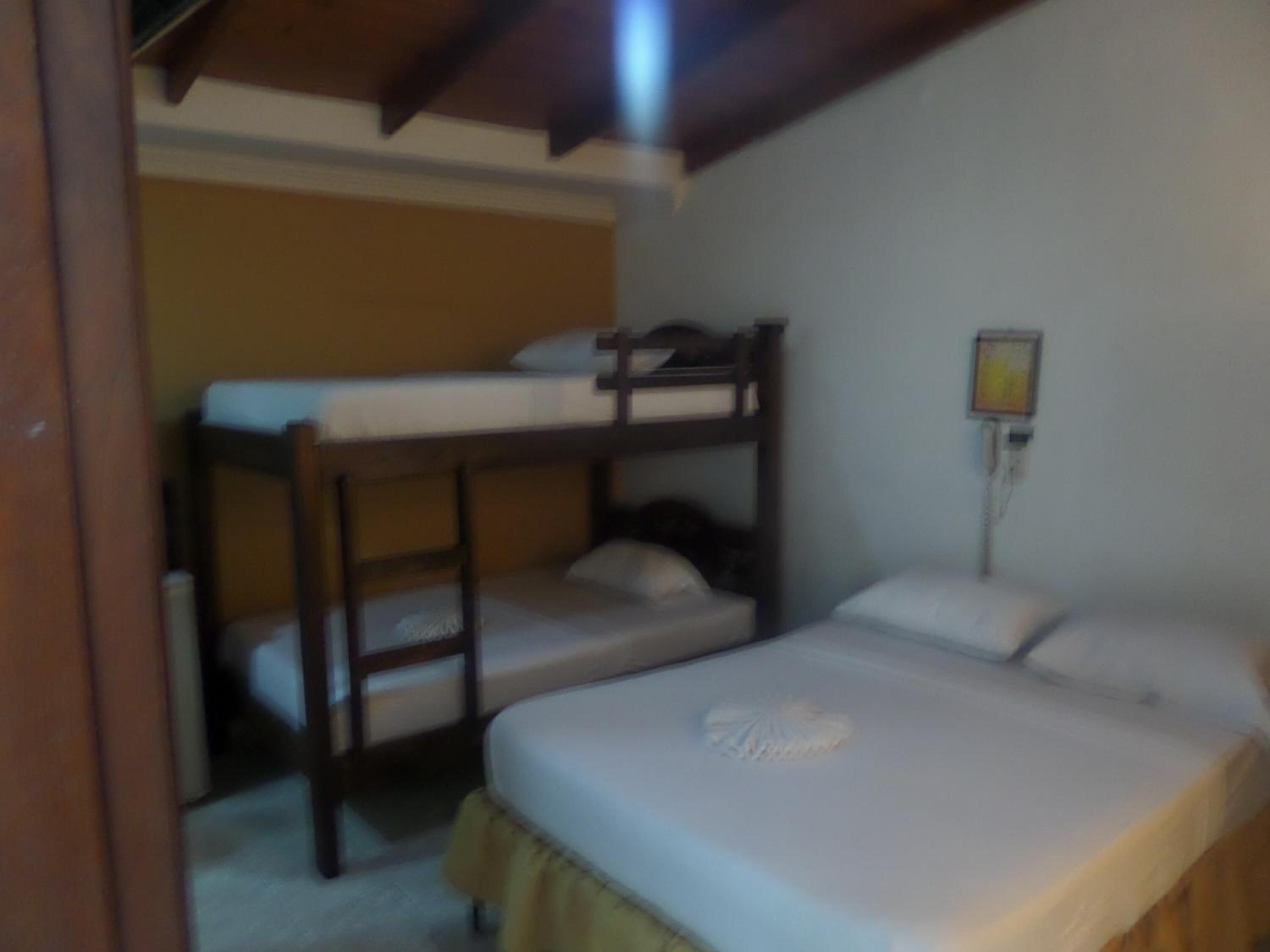 A bunk bed room with a single bed and a bunk bed.