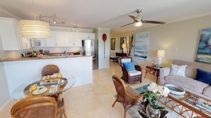 Enjoy a comfortable living space with a central island breakfast bar, sofa, and chair.