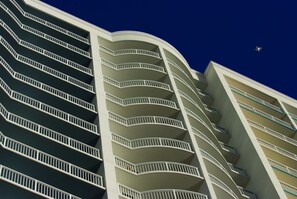 Hotel features a unique, curved facade with spacious balconies.