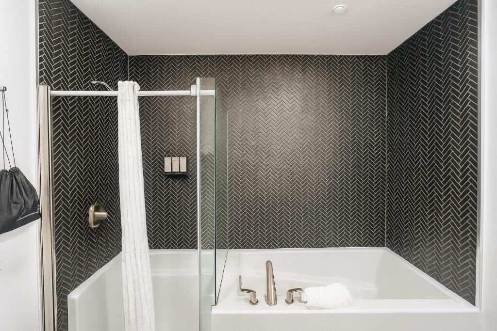 combined shower/bathtub, designer toiletries, hair dryer, towels