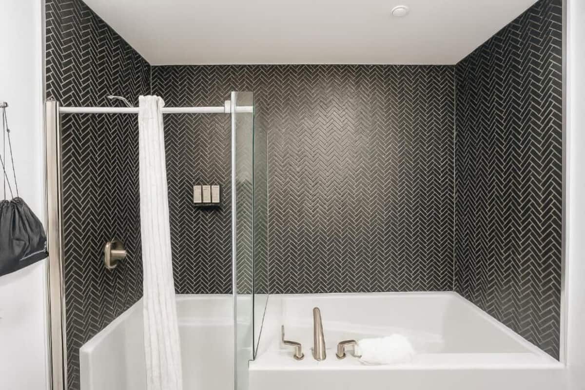 combined shower/bathtub, designer toiletries, hair dryer, towels