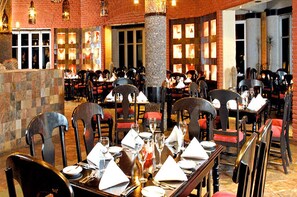 Enjoy a fine dining experience in a charming setting with elegant tables, comfortable seating, and rustic accents.