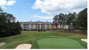 A golf course with a clubhouse in the background.