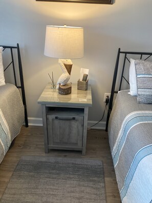 A bedroom with two beds, a bedside table with a lamp, a small drawer, and a nightstand. - Located on 18 HOLE PREMIERE GOLF COURSE, Near SunSet Beach, perfect Location!  (Calabash)