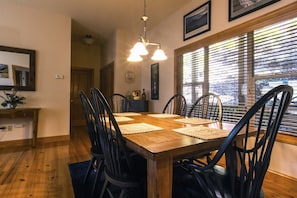 Enjoy meals in this dining area with a wooden table and six chairs, set with woven placemats.