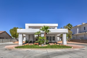 A modern two-story house with a covered patio, a well-maintained lawn, and a clear blue sky. - Modern 7000sf Villa, Private Basketball/tennis Court Pool Sleeps 24 (Las Vegas)