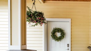 A stone pillar, a white door with a wreath, and a welcome mat. - Spacious Suite on Oregon Equestrian Estate (Tualatin)