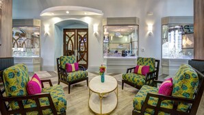 A lobby with four armchairs, a round coffee table, and a large arched doorway. - Piece of Heaven Pool Home by AV Dreams (Davenport)