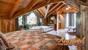 A cabin with a large bed, a bathtub, and a television. - Halfway to Heaven is perfect for a couples retreat or family getaway (Sevierville)