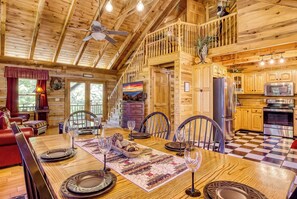 A spacious wooden cabin with a dining area, kitchen, and a balcony with a view. - Halfway to Heaven is perfect for a couples retreat or family getaway (Sevierville)