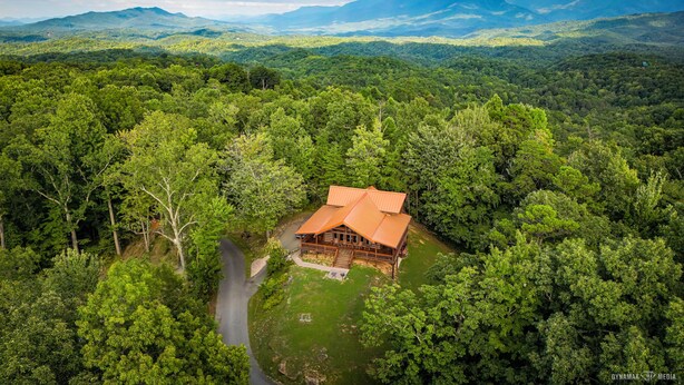 A cabin surrounded by dense forest with a clear view of the surrounding mountains. - Halfway to Heaven is perfect for a couples retreat or family getaway (Sevierville)