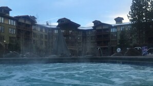 A hot spring area with a view of multi-story buildings in the background.