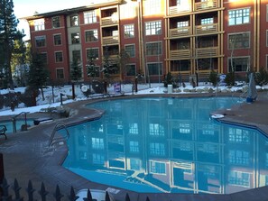 A swimming pool with a reflection of a multi-story building.
