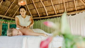 Experience a serene spa setting with a thatched roof, offering massage therapy sessions in a peaceful atmosphere.
