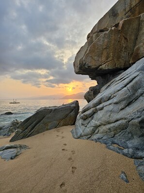 A rocky shoreline with a sunset in the background. - Amaca Beach Retreat - Puerto Vallarta South Shore (Quimixto)