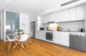 One Bedroom Apartment With Parking | Private kitchen | Fridge, microwave, oven, stovetop