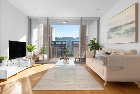 One Bedroom Apartment With Parking | Living area | 49-inch Smart TV with digital channels, TV