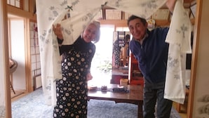 A room with a traditional Japanese interior, including tatami flooring, a low wooden table, and a sliding door. - PittINN Farm Keyaki (Inakadate-mura)