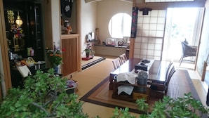 A traditional Japanese room with tatami flooring, a low table with a tea set, a shoji screen, and a sliding door leading to a balcony. - PittINN Farm Keyaki (Inakadate-mura)