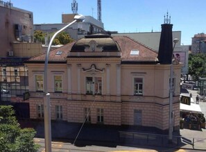 A historic building with a classic facade, large windows, and a prominent chimney. - Sobe-Rooms Kvatric (Zagreb)