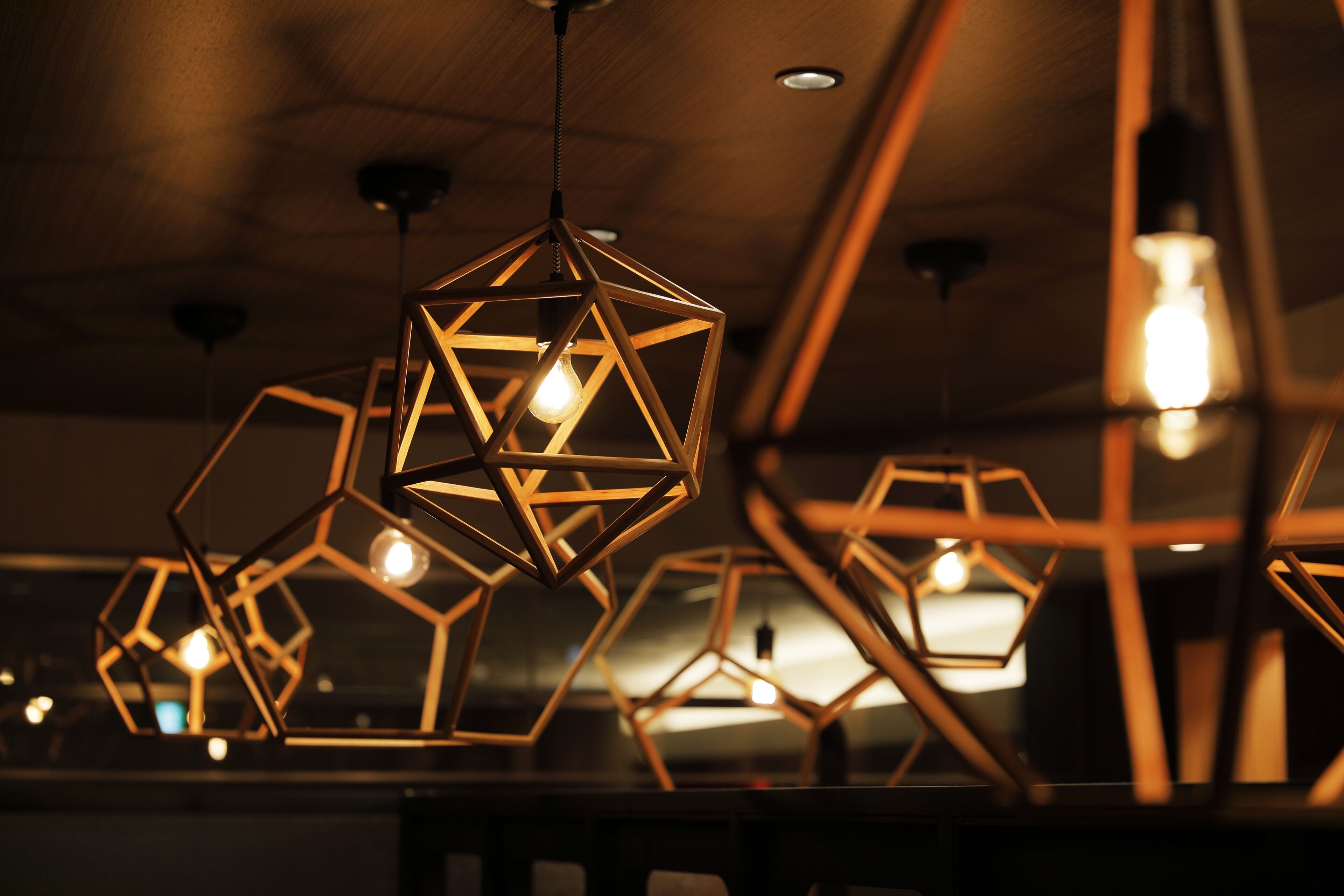 A modern interior with geometric pendant lighting fixtures.
