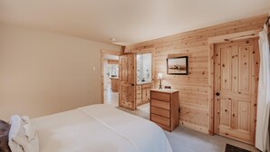 A bedroom with a bed, wooden wardrobe, a dresser, a mirror, and a picture on the wall. - 095GS - Hot Tub - WiFi - Pets Ok - Sleeps 4 (Deming)
