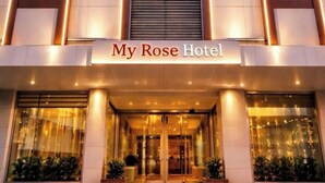 A hotel facade with a central entrance, illuminated by vertical lights, and the name 'My Rose Hotel' displayed above the entrance. - My Rose Hotel (Istanbul)