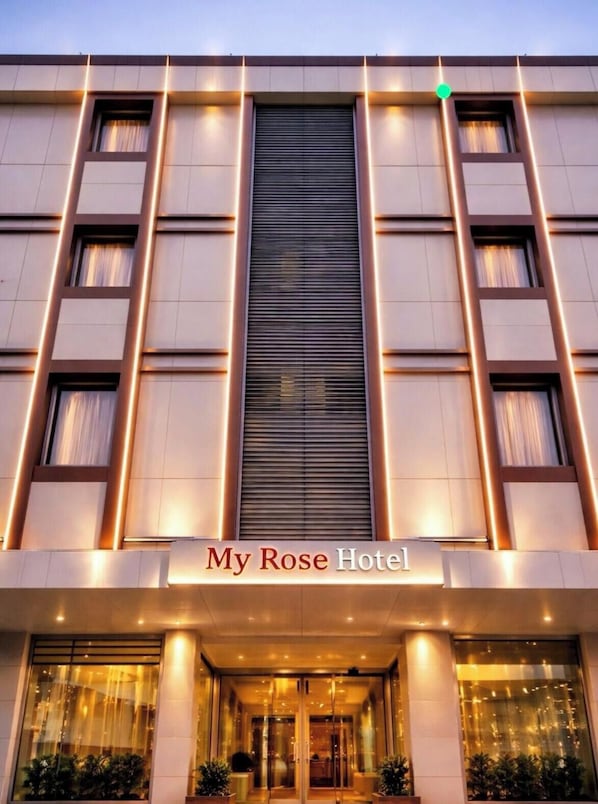 A hotel facade with a central entrance, illuminated by vertical lights, and the name 'My Rose Hotel' displayed above the entrance. - My Rose Hotel (Istanbul)