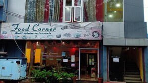 A multi cuisine restaurant named Food Corner with a signboard advertising various services like party orders and free home delivery. - Yelagiri Residency (Tirupattur)