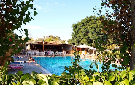 Seasonal outdoor pool, open 10:00 AM to 7:00 PM, pool umbrellas