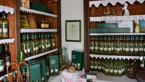 A wine cellar with shelves stocked with wine bottles and various wine-related items. - Weingut Seiner vlg. Kraxner (Sankt Stefan ob Stainz)