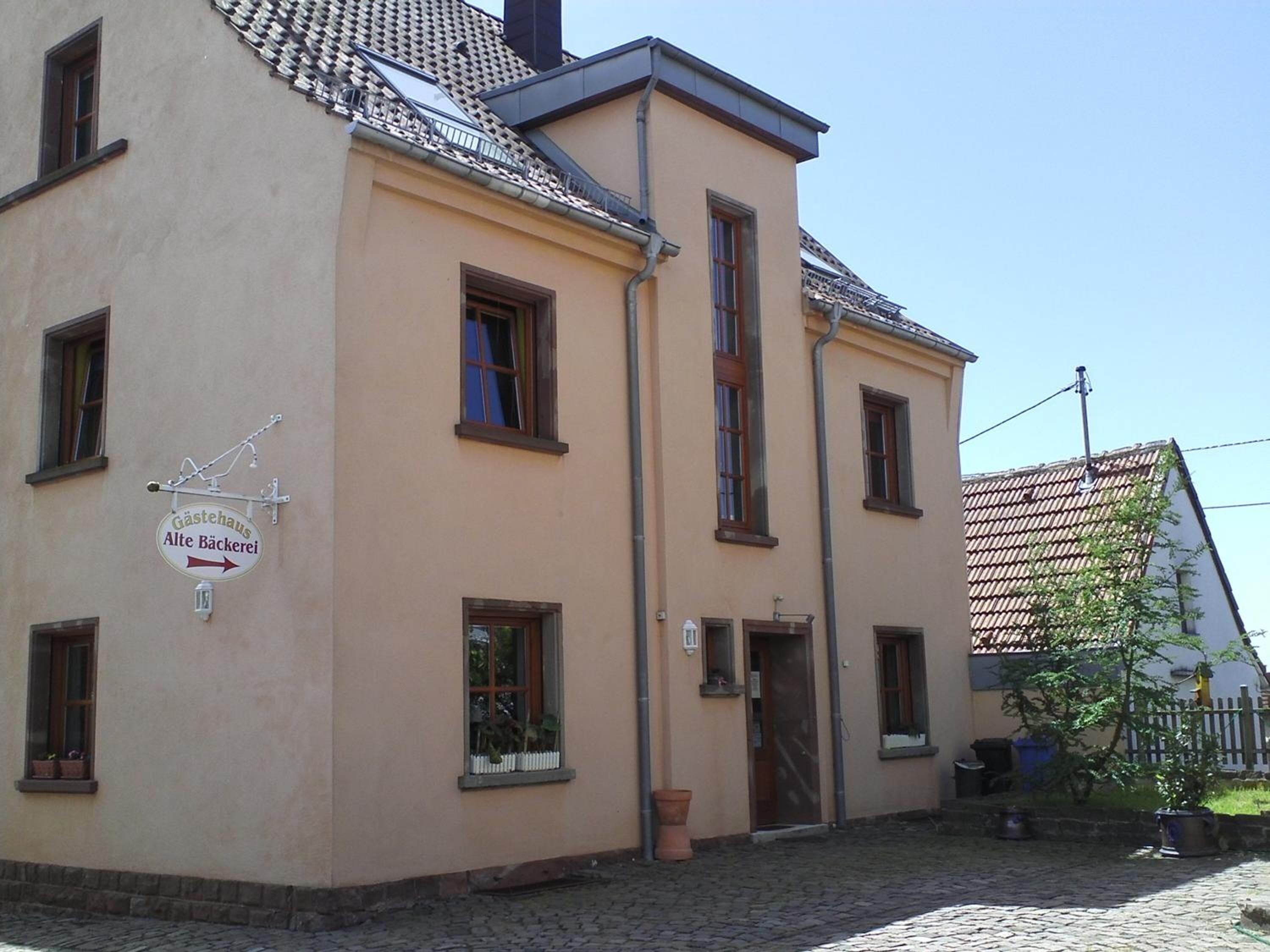 A building with a sign reading "Gästehaus Alte Bäckerei" indicating a guesthouse or bakery.