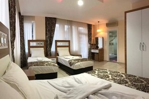 Family Room | Minibar, desk, free WiFi, bed sheets