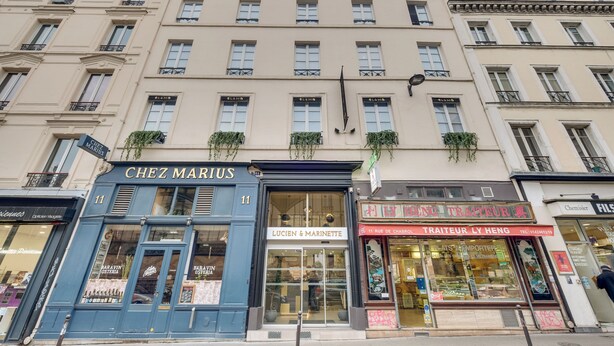 A building with multiple storefronts, including 'Chez Marius' and 'Lucien & Marinette'. - Hotel Lucien & Marinette (Paris)