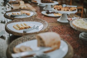 A buffet table with various dishes and utensils.