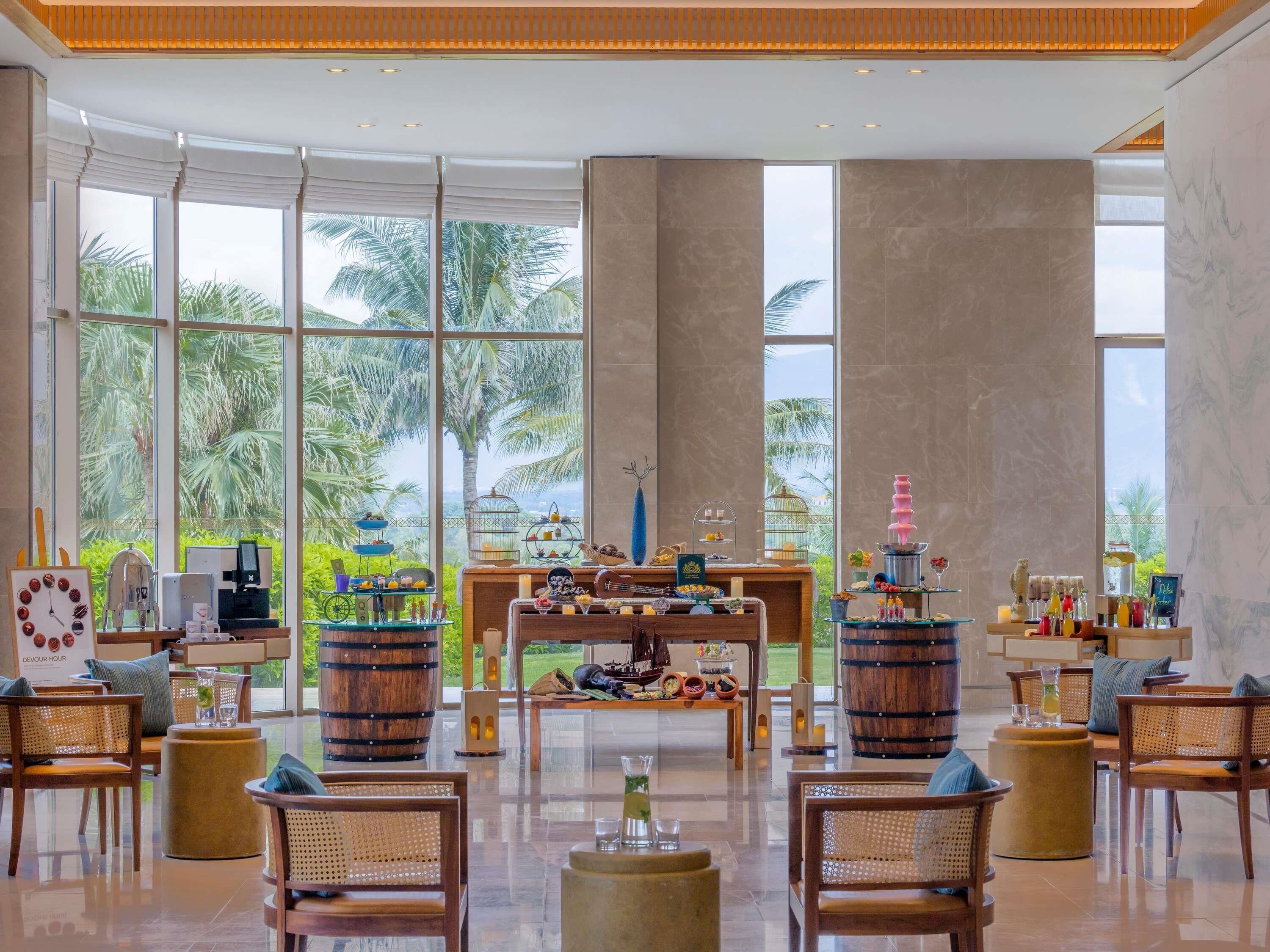 A spacious lobby with large windows, a reception desk, and a variety of seating arrangements.