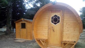 A wooden structure with a hexagonal window and a door labeled "FIGUIER". - Les Tonneaux de l'Eure Logement Insolite (Neuilly)